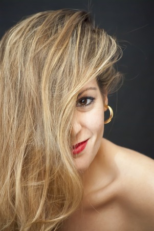 Portrait of Beautiful Young Woman Over Black Backgroundの写真素材