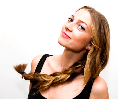 Portrait of Beautiful Young Woman Shaking Her Hair Over White Background