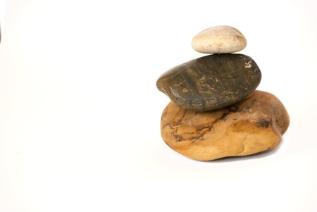 Three Piled Stones on white backgroundの写真素材