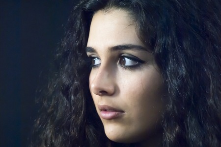 Portrait of Beautiful Young Woman Over Black Backgroundの写真素材