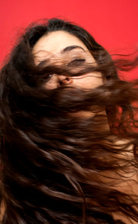 Portrait of Beautiful Young Woman Over Red Background