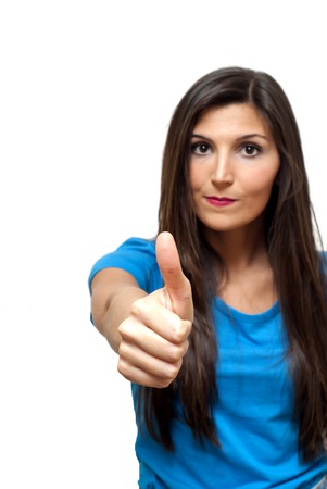 Portrait of Beautiful Young Woman  With The Thumb Upwards Over White Backgroundの写真素材