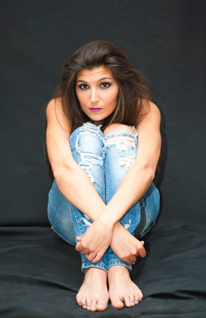 Portrait of Beautiful Young Woman Over Black Backgroundの写真素材