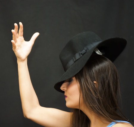 Portrait of Beautiful Young Woman With Hat Over Black Backgroundの写真素材