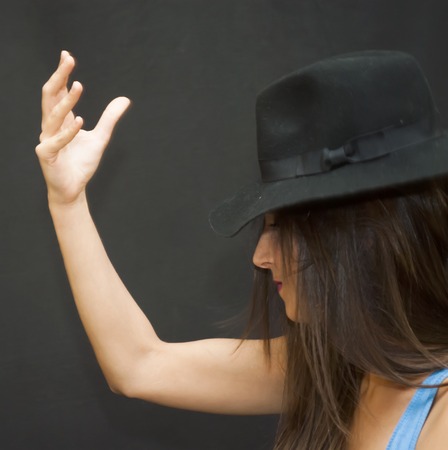 Portrait of Beautiful Young Woman With Hat Over Black Backgroundの写真素材