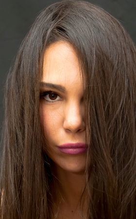 Portrait of Beautiful Young Woman Over Black Backgroundの写真素材