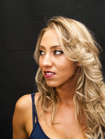 Portrait of Beautiful Young Woman Over Black Backgroundの写真素材