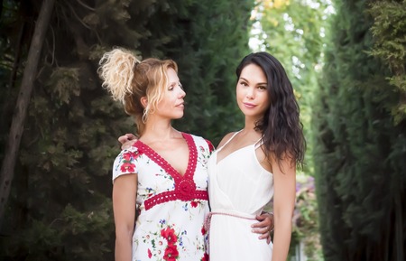 Portrait of Beautiful Young Woman and beautiful Middle Aged Woman  In The Park, that are mother and daughterの写真素材