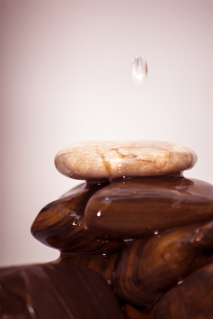 Drops of water falling on stonesの写真素材