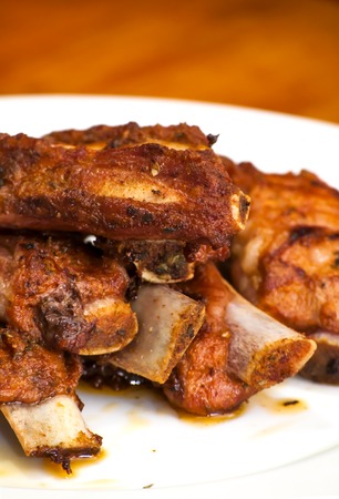 Roasted pork ribs on a white plateの写真素材