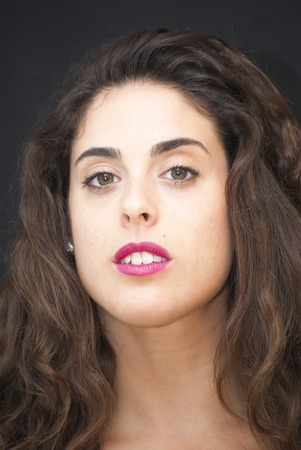 Portrait of Beautiful Young Woman Over Black Backgroundの写真素材