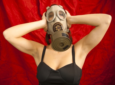 Portrait of Sexy Woman with gas mask Over Black Backgroundの写真素材