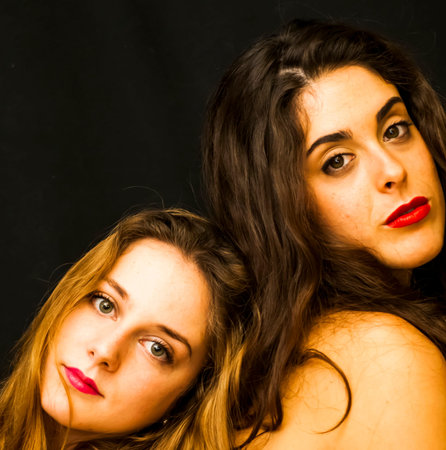 Portrait of Two beautiful women  Over Black Background