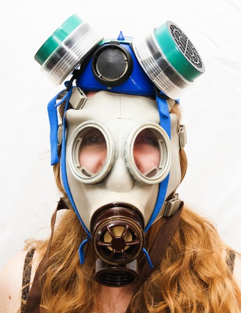 Portrait of Beautiful Young Woman with gas mask on white backgroundの写真素材