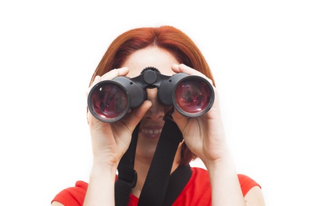 Portrait of Beautiful Young Woman  looking through binoculars  Over White Backgroundの写真素材
