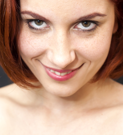 Portrait of Beautiful Young Haired Woman Over Black Backgroundの写真素材