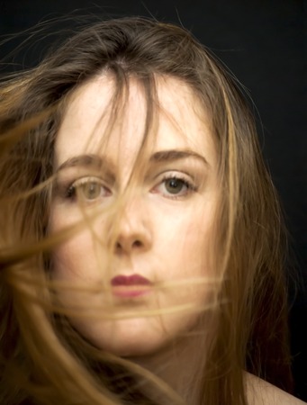 Portrait of Beautiful Young Woman Over Black Backgroundの写真素材