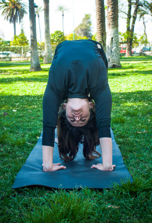Beautiful woman practicing yoga in the park