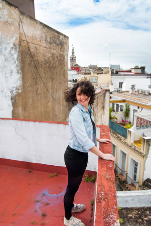 Portrait of Beautiful Young Woman on the roof of a typical Mediterranean cityの写真素材