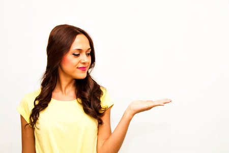 Portrait of a beautiful woman with her open hand on white backgroundの写真素材