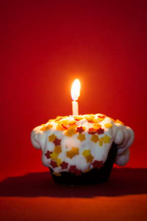 Cupcake birthday or Christmas party with a candleの写真素材