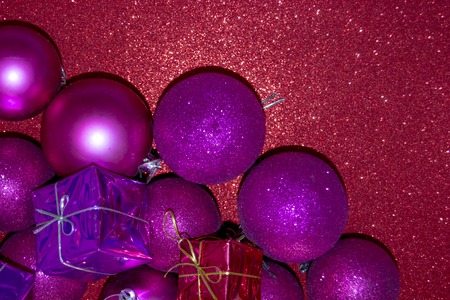 Gifts and Christmas decorations on bright red backgroundの写真素材