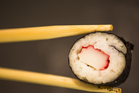 Tasty Pieces of sushi on a black stoneの写真素材