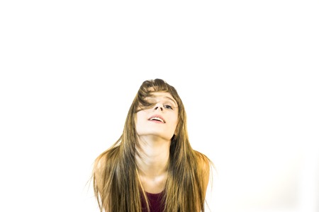 Portrait of Beautiful Young Woman Shaking Her Hair Over White Backgroundの写真素材