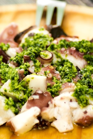 Octopus with paprika, typical dish of Spain, on a wooden tableの写真素材