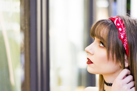 Portrait of a beautiful woman  in the street window shoppingの写真素材
