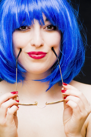 Beauty Woman With Blue Wig And Sunglasses Portrait Isolated over Black Backgroundの写真素材