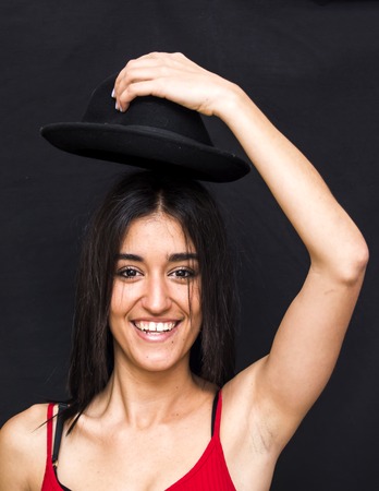 Portrait of a beautiful woman  with hat on black backgroundの写真素材