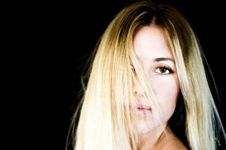 Portrait of a beautiful woman on black backgroundの写真素材