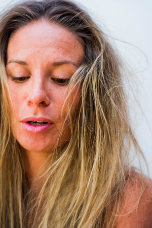 Portrait of the face of a beautiful blond woman on white background