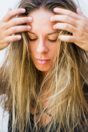 Portrait of the face of a beautiful blond woman on white backgroundの写真素材