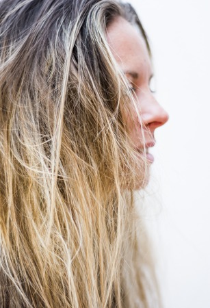 Portrait of the face of a beautiful blond woman on white backgroundの写真素材