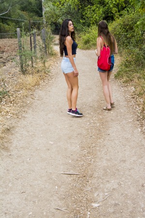 Two beautiful women hiking in nature  on a mountain roadの写真素材