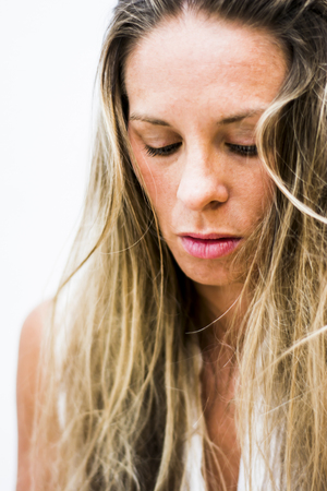 Portrait of the face of a beautiful blond woman on white backgroundの写真素材