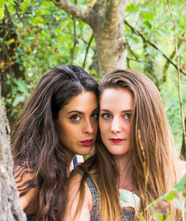 Two beautiful women in nature  on a mountain forestの写真素材