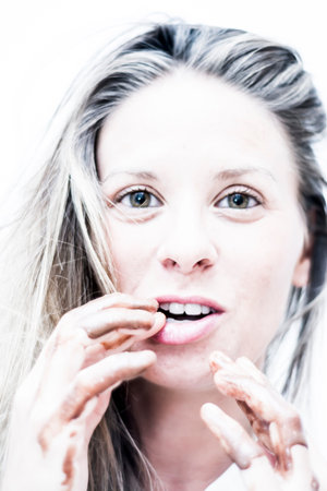 Portrait of Beautiful woman with fingers stained with chocolate