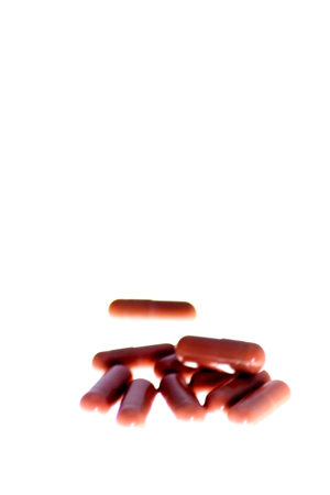 Lot of red pills on white backgroundの写真素材