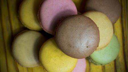 Colored macarons isolated on wooden dish, typical French dishの写真素材