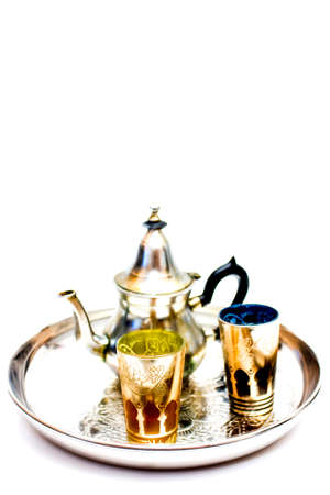 Group of teapot and glasses of oriental tea on a tray on white backgroundの写真素材