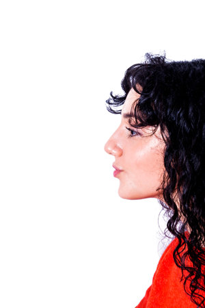 Portrait of a beautiful woman with red sweater giving an air kiss on white background