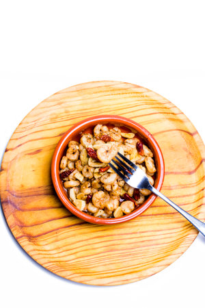 Tasty Prawns with garlic and cayenne in a ceramic bowl on a wooden trayの写真素材