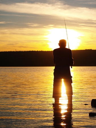 Fisherman in sunsetの写真素材