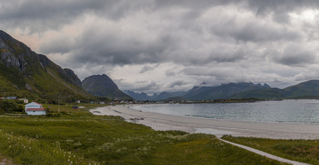 Sand beach, mountains, clouds and some gras in Lofotenの写真素材