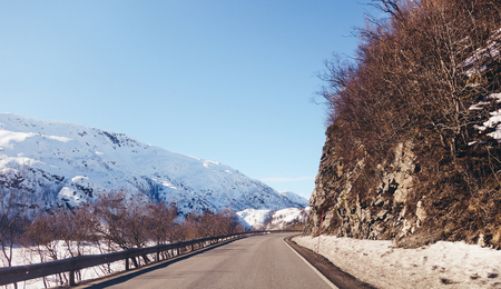Norway, sunny day, narrow roads of Lofoten on a spring day with snowの写真素材