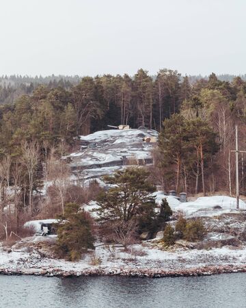 Defense positions behind trees in one of the Stockholm archipelago islands on a snowy day, Swedenの写真素材