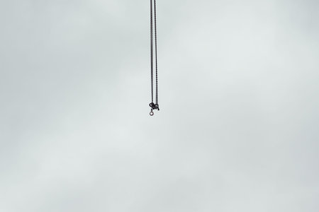 Construction site cranes chains with hooks in the air , Stockholm Sweden